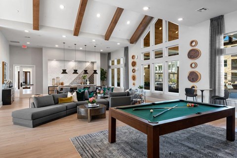 a pool table is in the center of a living room